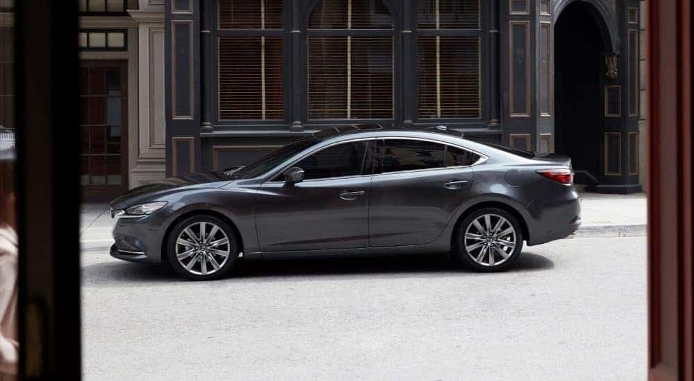 A gray 2019 Mazda6 is shown parked on a city street.