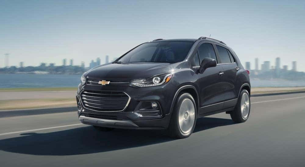 A gray 2020 Chevy Trax is shown driving near a city